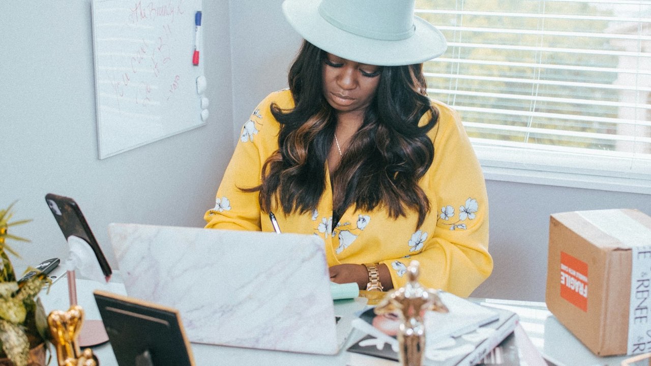 A job seeker taking notes at her laptop in a home office